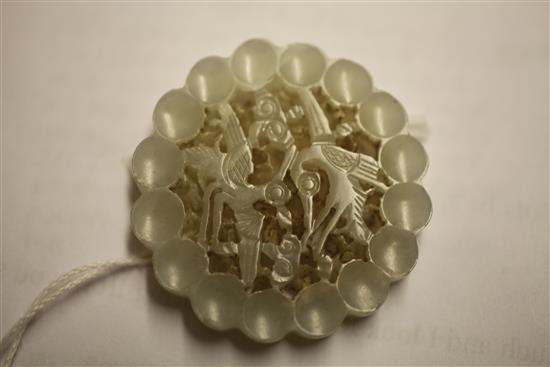 A Chinese pale celadon jade disc, 17th / 18th century, 4.2cm